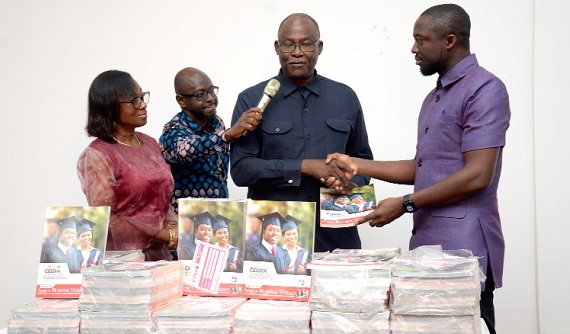 Ekwow  Spio-Garbrah (3rd from left), Chairman of ABCDE, with Dr. Awura Mansah Spio-Garbrah (left), his wife, presenting the books to Hayford Siaw, CEO of the GhLA 