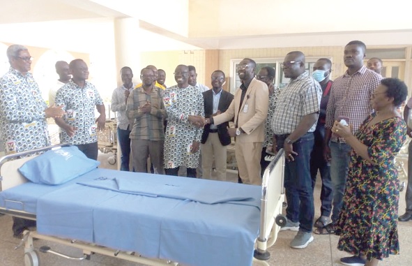 Daniels Kwabena Obeng-Ofori (4th from  left), Vice-Chancellor of the CUG, exchanging pleasantries with Adams Umar Mengu (4th  from right), Deputy Administrator of the Sunyani Regional Hospital, after the presentation