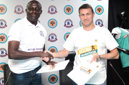Warren Adams (right), Chief Executive Officer of the FNB, exchanging documents with Benjamin Ahulu, Chairman of the Dansoman Keep Fit Club, after signing the agreement 