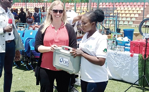 Shannon Senefeld (left), Senior Vice-President for Overseas Operations at CRS, presenting a start-up kit to a beneficiary