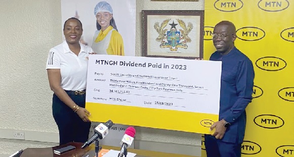 Antoinette Kwofie (left), Chief Finance Officer, MTN, presenting the dummy cheque to Dr John Ofori-Tenkorang, Director-General of SSNIT