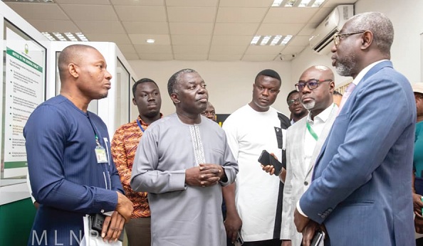 Benito Owusu-Bio (2nd from left), Deputy Minister of Lands and Natural Resources, interacting with Benjamin Arthur (right), acting Executive Director of the Lands Commission