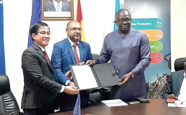 Dr Bryan Acheampong (right), Minister of Food and Agriculture; Irchad Razaaly (middle), EU Ambassador to Ghana, and Yurdi Yasmi, FAO Representative in Ghana, displaying the agreement after appending their signatures 