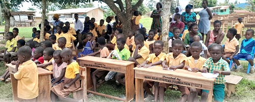 Schoolchildren seated on the new dual desks provided by the Nana Adjei Kyerema Foundation