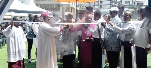 Nana Otwasuom Nyampong (arrowed), Board Chairman of Genser Power Africa, being helped to cut the tape for the use of the facility. Inset: The STEM facility
