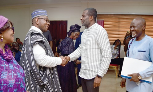 Davis Owusu Mensah (left), member of the Afro Root Carnival Organising Team, exchanging pleasantries with Mark Okraku Mante, Deputy Minister of Tourism, Arts and Culture