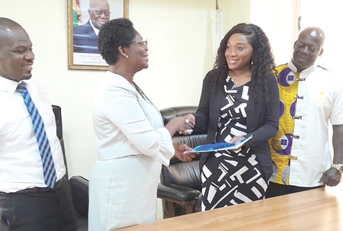 Philomina Woolley (2nd from left), acting Registrar, N&amp;MC, exchanging the agreement with Yvonne Commodore-Mensah, President, G-DNA. With them are Dr Daniel Kwame Apau (right), Director, G-DNA, and Ampem Darko Abbey (left), the Deputy Director in charge of Operations, N&amp;MC 