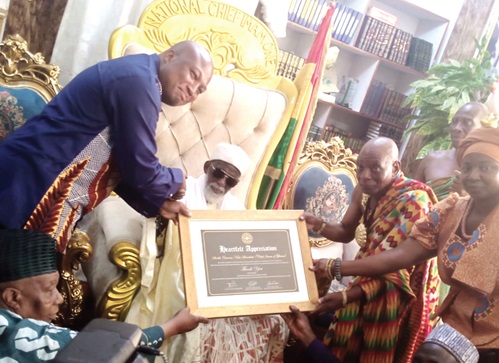 Samuel Okudzeto Ablakwa (left), MP for North Tongu, with the support of one of the traditional leaders, presenting a citation to Sheikh Osman Sharubutu (seated), National Chief Imam