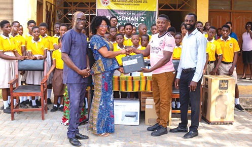 Richard Nartey (2nd from right), CSR Manager, ASA Savings and Loans, presenting the equipment to Mary Agbeko (2nd from left), School Improvement Support Officer, Dansoman Cluster of Schools. With them are Raphael Agyarkwa (right), Dansoman Branch Manager, Asa Savings and Loans; Emmanuel Bachuri (left), Head Teacher, Dansoman ‘2’ Basic School, and some students of the school