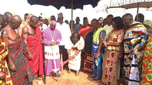 Mrs Ofosu-Adjare (middle, bending), MP for Techiman North, cutting the sod to signify the commencement of work. Looking on are the Most Rev. Nyarko (3rd from left), Catholic Bishop of the Techiman Diocese, and some traditional rulers in the area