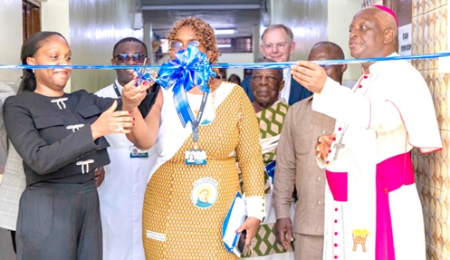 Most Rev. Joseph Afrifah-Agyekum  (right), Catholic Bishop of the Koforidua Diocese, assisting Dr Kanyinsola Oyeyinka (middle), Vice-President of EASE Healthcare and Managing Director of EASE Ghana, to cut the tape