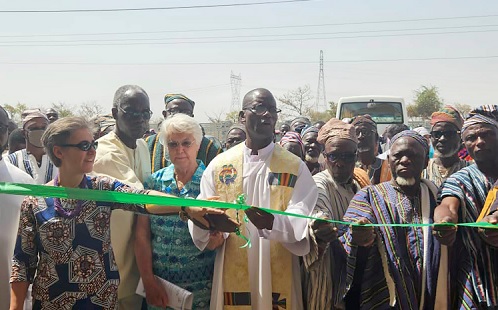 Rev. Fr Cyprain Kuupol (middle), Provincial Superior of Divine Word Missionaries, being assited by Sister Elizabeth Newman (2nd from left), MD of OTC Nsawam, and some traditional authorities to inaugurate the facility