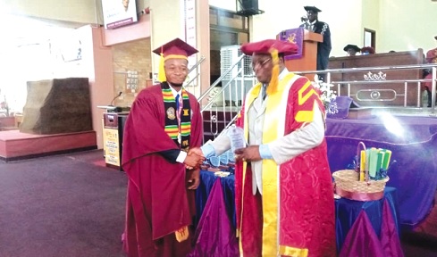 Bright Kwesi Gbadago (left), Best Student, MPhil Strategic Management, receiving a prize from Prof. Stanley Saamoah Moffatt, President, DLIBT