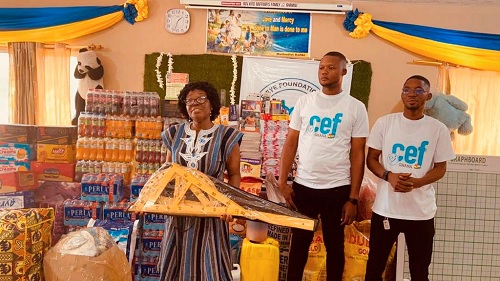 Madam Rejoice Dei Forson, Caretaker of the village, received the items on behalf of the children. With her are Philip Biney (middle), the Project Manager of CEF-Ghana, and Edward Hammond Adjinku, the Founder of CEF-Ghana