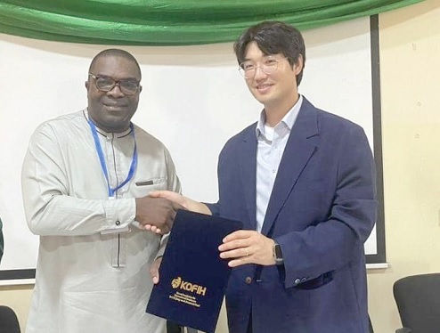 Dr Eric Ngyedu, CEO of CCTH, exchanging the signed MOU with Bomin Yang, Country Director of KOFIH