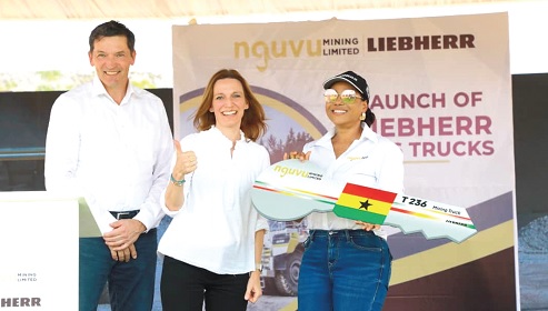 Angela List (right), CEO of Nguvu Mining Limited, with a symbolic key presented to her by Dr Jörg Lukowski (left), Executive Vice President of Liebherr Mining, and Sophie Albrecht (middle), Member of the Administrative Board of Liebherr International 