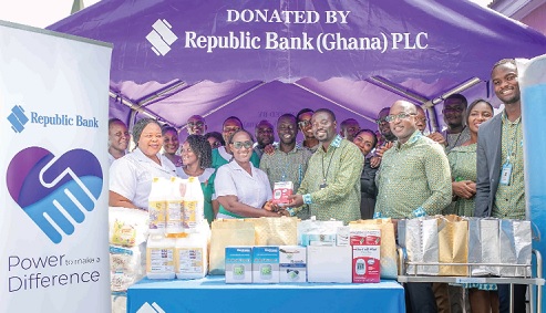 Jacob Hobenu (3rd from right), Head, Corporate Banking, presenting the items to Alice Akuoko Foli (2nd from left), Principal Nursing Officer