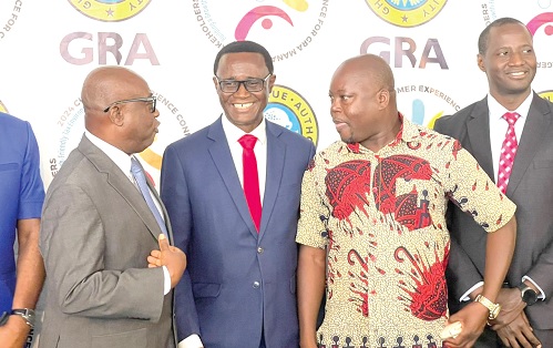 Dr Oteng-Gyasi, Board Chair of the GRA, interacting with Sampson Asaki Awingobit, Executive Director of Importers and Exporters Association of Ghana, and Dr Ammishaddai Owusu Amoah