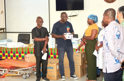 Nana Yaw Asante (2nd from left), Managing Director of Rikair Company Limited, presenting some of the items to Dr Maureen Brese (3rd from right), a Medical Officer at the Maamobi General Hospital. With them is Philip Creech Jones of Rikair (left) and other staff of the hospital