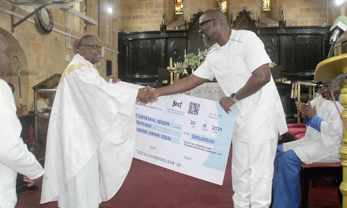Edwin Provencal (right), Managing Director, BOST, presenting a dummy cheque to Rt. Rev. Dr Daniel Slyavnus Mensah Torto, Bishop of the Anglican Diocese of Accra. Picture: ESTHER ADJORKOR ADJEI