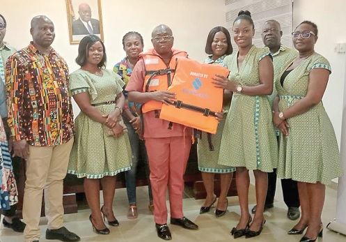 Claudia Koranteng (3rd from right), a member of the Marketing and Communication, Corporate Affairs Department of Republic Bank Ghana, presenting the jackets to Charles Odoom, Weija Gbawe Municipal Director of Education. With them are some staff of the bank and the assembly