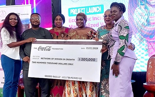 Mawulawoe Awity (right), Executive Director of NEWIG, Joyce R. Aryee (2nd from right), Executive Director of Salt and Light Ministries, and David Appiah (2nd from left), Senior Manager, Communications of the Coca-Cola Foundation, displaying a dummy cheque from the Coca-Cola Foundation 