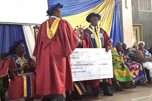 Prof. Felix Narku Engman (left), Dean of Faculty of Applied Sciences, receiving the Chancellor award of GH¢10,000.00 on behalf of the best ICT student from Prof. Gabriel Dwomoh, the VC