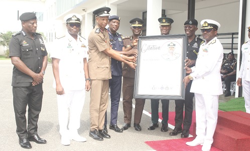 The heads of security agencies presenting a citation to Vice Admiral Seth Amoama (right) 