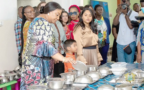 Rebecca Akufo-Addo (left), the First Lady, inspecting some of the food at the Sunshine Hostel. With her is Arya Ali (arrowed), Guyana’s First Lady