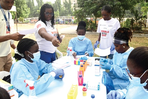 Research scientists from the Noguchi Memorial Institute for Medical Research, University of Ghana, testing samples of people who participated in a health screening exercise to mark the World Neglected Tropical Disease Day