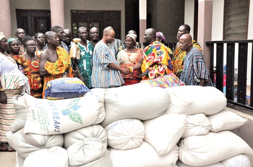 Togbe Korku Dzaga XI (2nd from right), Paramount Chief of Klefe, presenting the items to Togbe Kosi Nego VI (in smock), Mankrado of Mepe, while other members of the visiting team and elders of Mepe look on