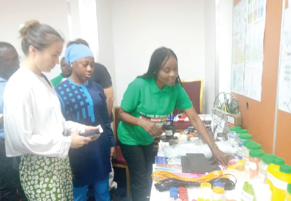  Vivian Ahiayibor (right), the Managing Director of City Waste Recycling Limited, showing some innovative products developed by pupils across the country 