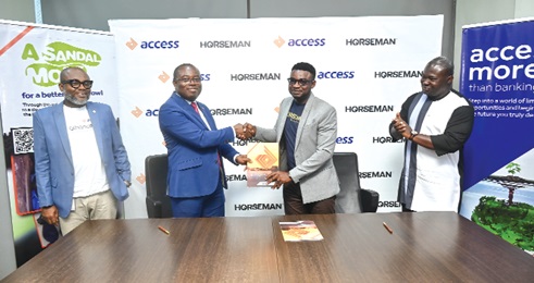 Kafui Bimpe (left), Group Head, Business Banking, Access Banking, presenting the agreement to Tonyi Senayah (right), Chief Executive Officer of Horseman Shoes