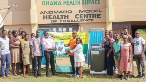 Mary Agidi (right), Physician Assistant in charge of Anomabo Model Health Centre, and Jerome Kwesitey, representative of Mfantseman Municipal Director of Health Services, receiving the items from Addai-Boateng Bediako, Branch Manager for ASA, Anomabo