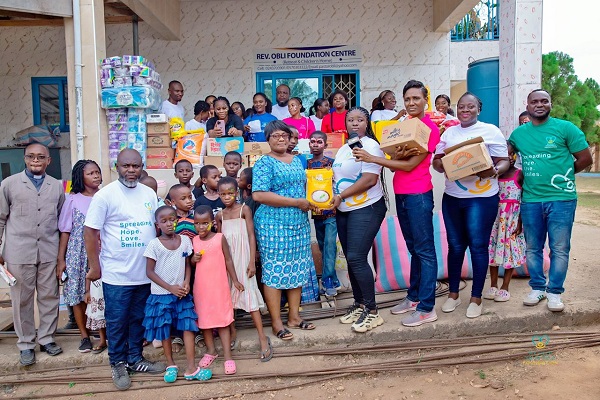 Members of Myhelp-Yourhelp Foundation presenting items to managers of Rev. Obli Foundation Centre
