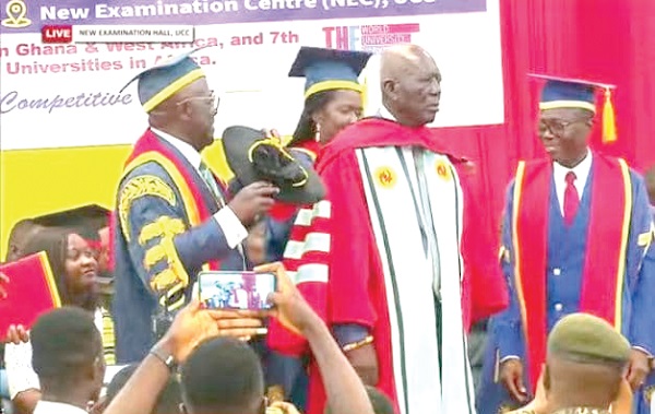 Osabarimba Kwesi Atta being robed by Sir Jonah (left), Chancellor, Prof. Johnson Nyarko Boampong  (right), Vice-Chancellor, and another official of the university