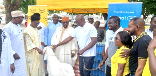 Sheikh Abdul Haroun Moomen (3rd from left), Ashanti Regional Chief Imam, receiving the ram and food items from Simon Amoh (4th from left), acting General Manager, MTN Northern Business District, during the presentation ceremony at the Kumasi Central Mosque