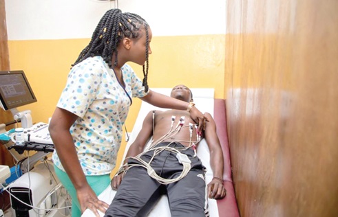A cardiac nurse at Yaaba Medical Services performing an electrocardiogram test on a patient