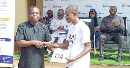 Kwasi Adu-Gyan (left), Bono East Regional Minister, presenting a certificate to Jeremiah Issahaku, one of the beneficiaries