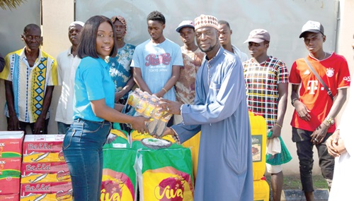 Sandra Amarquaye (left), Corporate Communications Manager of Karpowership Ghana, making a symbolic presentation of the items to Mohammed Moukhtar Tijani, Imam of the Umar AL-Mukhtar Mosque