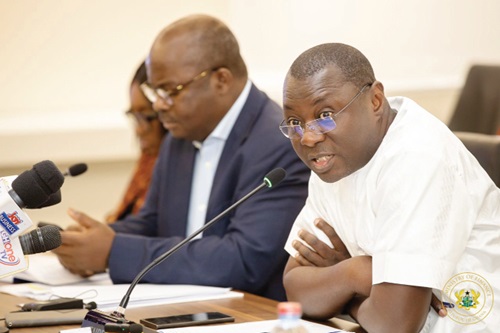 Dr Mohammed Amin Adam (right), the Minister of Finance, speaking during the meeting. With him is  Dr Ernest Addison, the Governor of Bank of Ghana