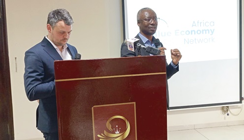 Professor Michael Ekow Manuel (right), the Academic Dean at the World Maritime University, being assisted by Dr Thomas Roslyng Olesen, the Head of Maritime Research Alliance, to launch the Africa Blue Economy 
