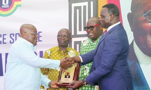 President Akufo-Addo (left) receiving a citation from Dr Yaw Adutwum  after the launch of the NSS Policy in Accra. With them are Osei Assibey Antwi (2nd from left) and Nii Odoi Tetteyfio, Board Chairman, NSS. Picture: SAMUEL TEI ADANO