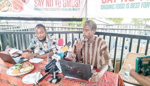Edwin Kweku Andoh Balfour (right), Communications Director, Food Sovereignty Ghana,  addressing the media in Accra. Seated by him is  Bismark Owusu Nortey, Programmes Officer, Peasant Farmers Association of Ghana 