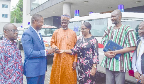 Dr Benard Okoe Boye, the Minister of Health designate, presenting the keys to the water tank for the Tamale Teaching Hospital to Shani Alhassan Shaibu, the Northern Regional Minister, while Miriam Coffie, a Board Member of the Tamale Teaching Hospital, and other officials look on