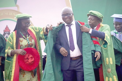 Prof. Rita Akosua Dickson (left) and Prof. Ellis Owusu-Dabo (right), Pro VC, KNUST, decorating Prof. Nathaniel Boso, after he delivered a speech at the Great Hall, KNUST.  Picture: EMMANUEL BAAH