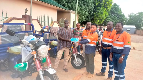 Baoli Feng (3rd from right), Vice-President in charge of General Administration, Public Relations and Security of the company, making a presentation to a representative of one of the beneficiary communities