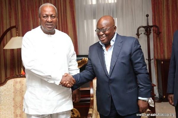 Former President Mahama (left) and President Akufo-Addo in a warm handshake 