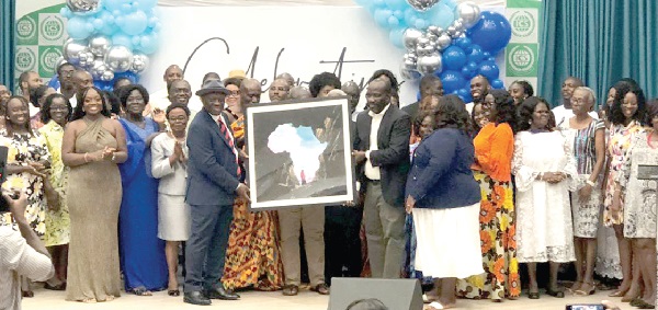 Israel Titi Ofei (in hat) being presented with an artwork by alumni of  SOS-Hermann Gmeiner International College