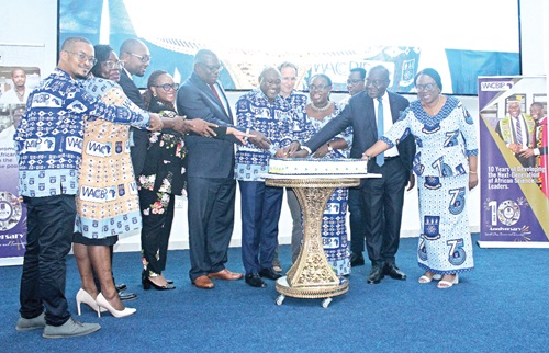 Prof. Gordon Awandare (4th from right), Director of WACCBIP and Pro-Vice Chancellor, Academics and Student Affairs, being assisted by Prof. Nana Aba Appiah Amfo (3rd from right), Vice-Chancellor, UG; Dr Darius Osei (2nd from right), Technical Advisor to Dr Bernard Okoe Boye, Minister of Health; Emeritus Prof. Ernest Aryeetey (5th from left), former Vice-Chancellor, UG, and some officials of WACCBIP to cut the anniversary cake. Picture: ERNEST KODZI 